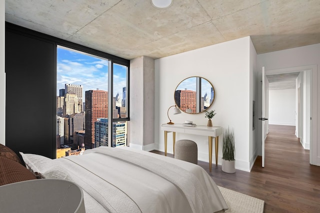 bedroom featuring expansive windows and dark hardwood / wood-style floors