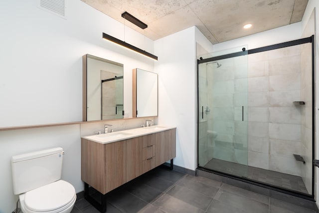 bathroom with tile patterned floors, vanity, toilet, and an enclosed shower