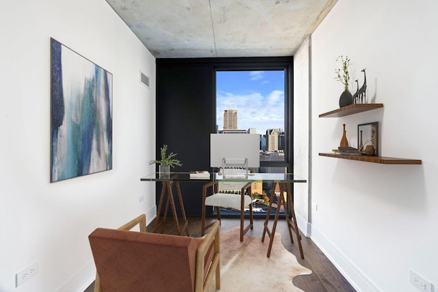 office area with wood-type flooring and a wall of windows