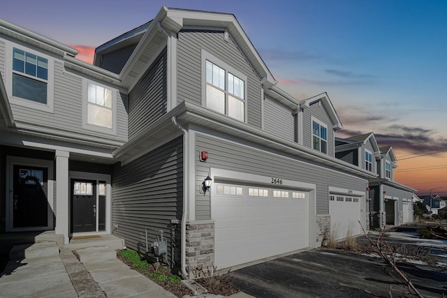 property exterior at dusk featuring a garage