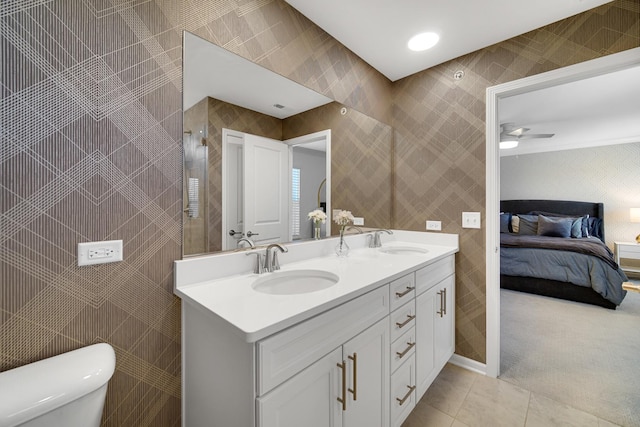 bathroom with toilet, ceiling fan, tile patterned flooring, and vanity