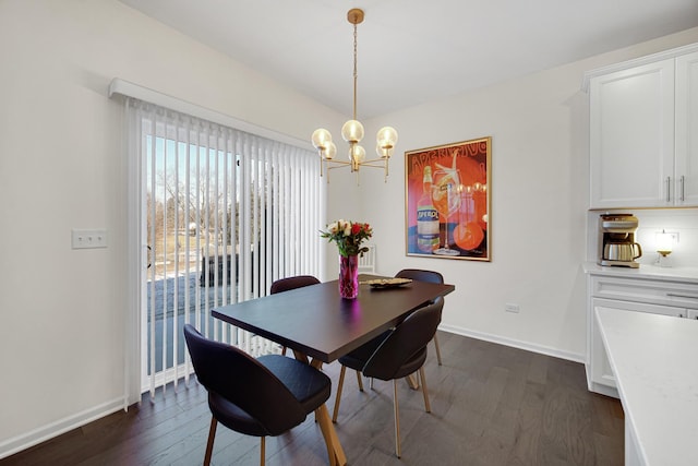 dining area with a chandelier and dark hardwood / wood-style floors