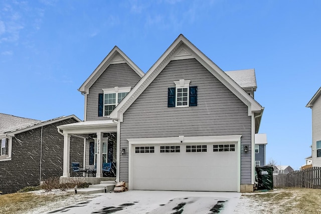 view of front property with covered porch and a garage