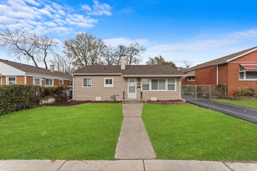 ranch-style home with a front lawn