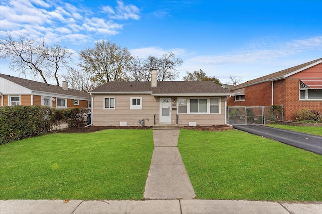 ranch-style home with a front lawn