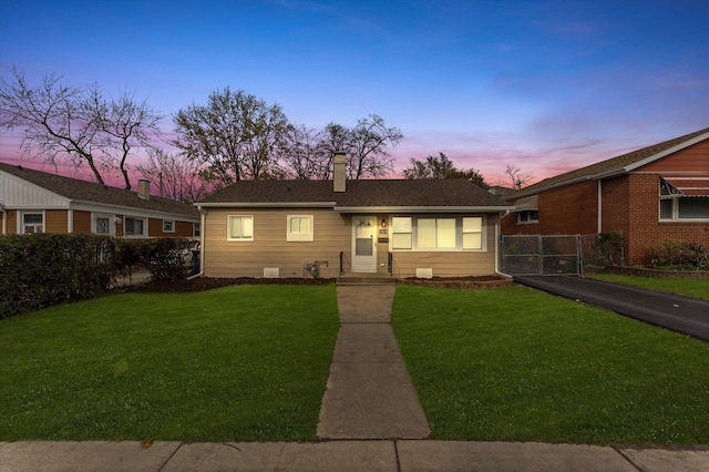 ranch-style house featuring a yard