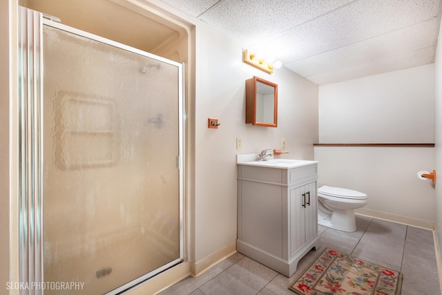 bathroom with vanity, a shower with door, tile patterned flooring, and a drop ceiling