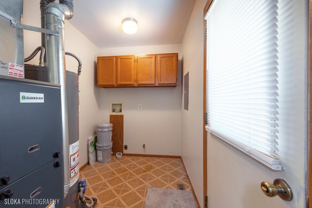 laundry room with heating unit, hookup for a washing machine, and cabinets