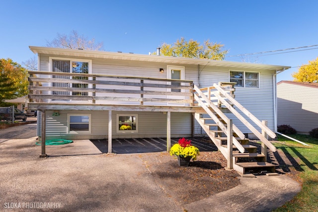 back of house with a wooden deck