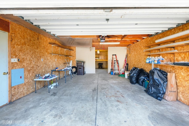 garage featuring electric panel and a garage door opener