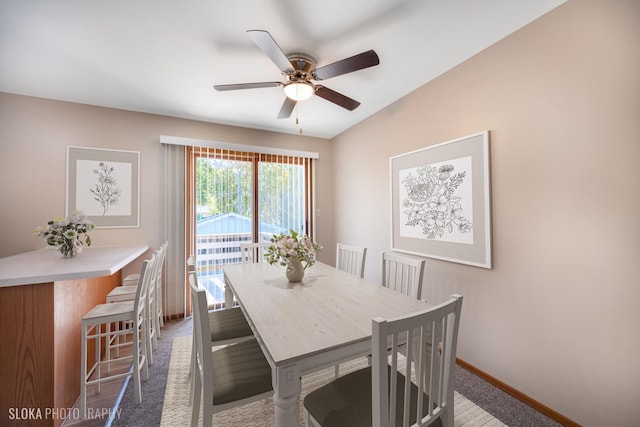 carpeted dining room featuring ceiling fan