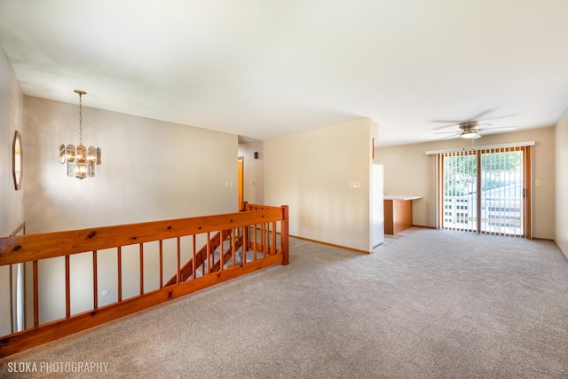 unfurnished room with light carpet and ceiling fan with notable chandelier