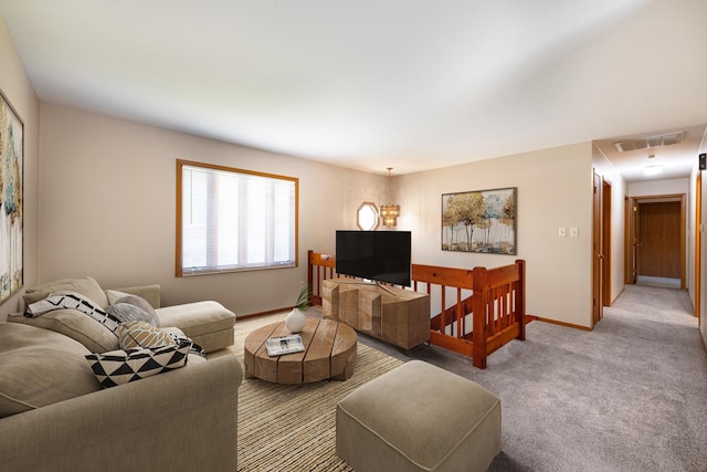 carpeted living room featuring a chandelier