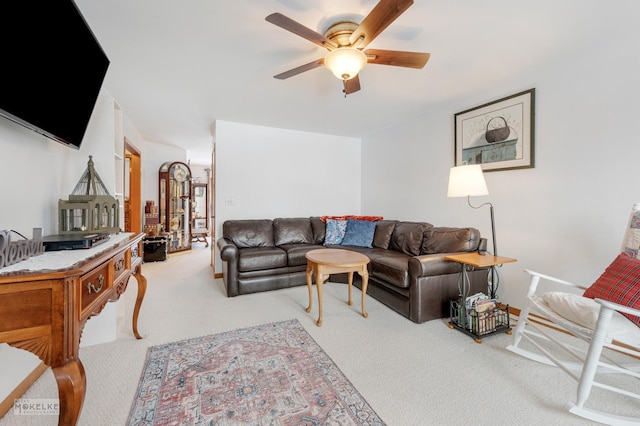 carpeted living room with ceiling fan