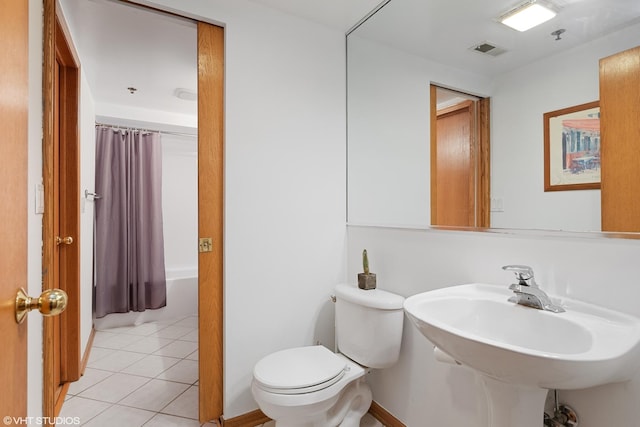 full bathroom with visible vents, toilet, shower / bath combo with shower curtain, a sink, and tile patterned flooring