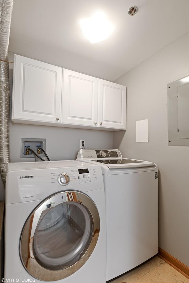 clothes washing area with cabinet space, electric panel, baseboards, and washer and dryer