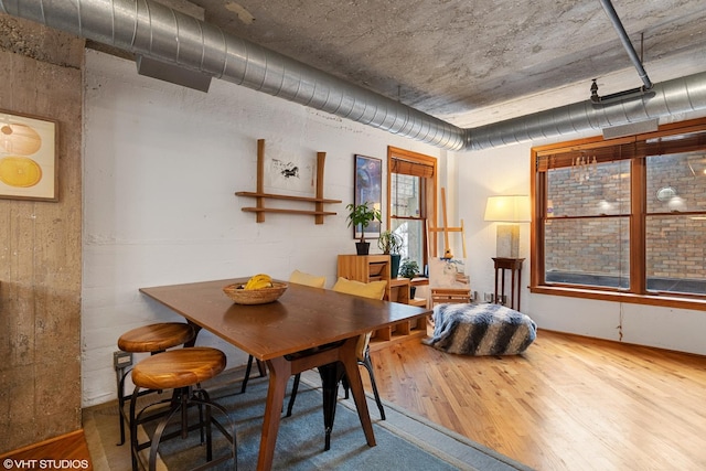 dining space with wood finished floors