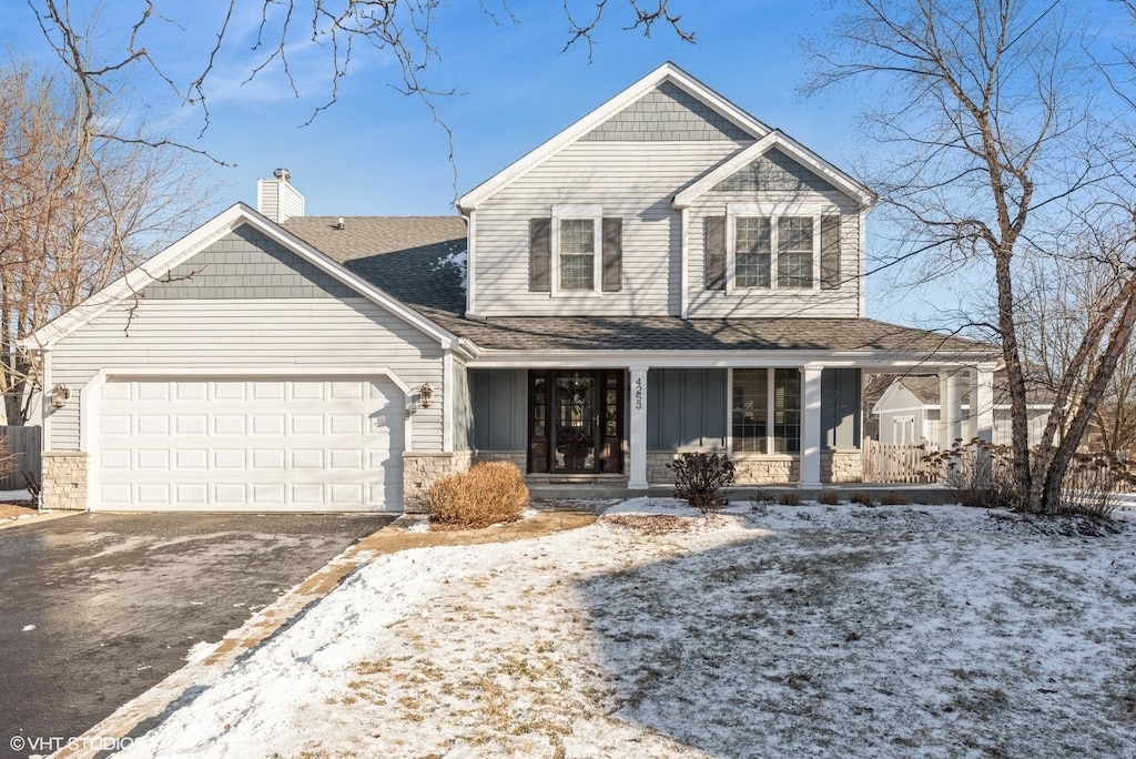 front of property featuring covered porch and a garage