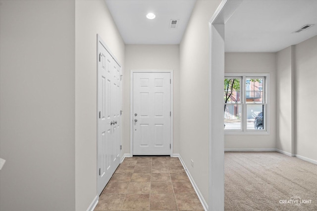 corridor featuring light colored carpet