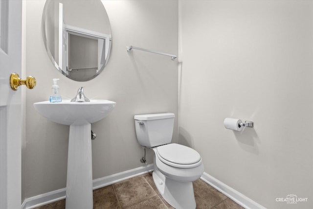 bathroom with toilet and tile patterned floors