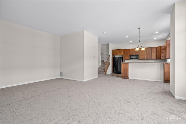 unfurnished living room featuring light carpet