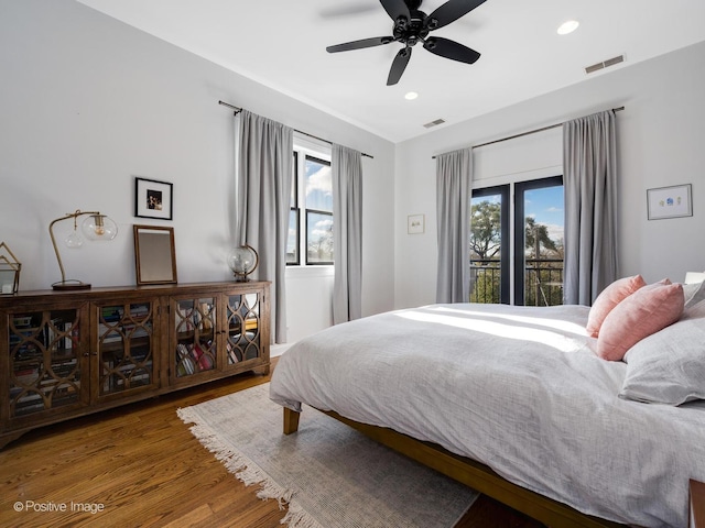 bedroom with hardwood / wood-style floors, access to outside, and ceiling fan