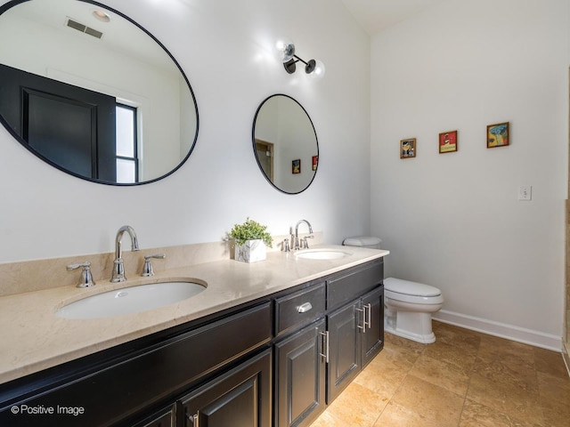 bathroom featuring toilet and vanity