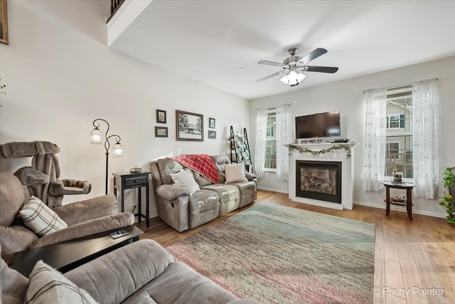 living room with ceiling fan and light hardwood / wood-style floors