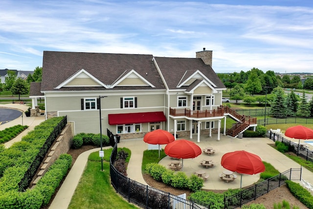 back of house featuring a fire pit and a patio area