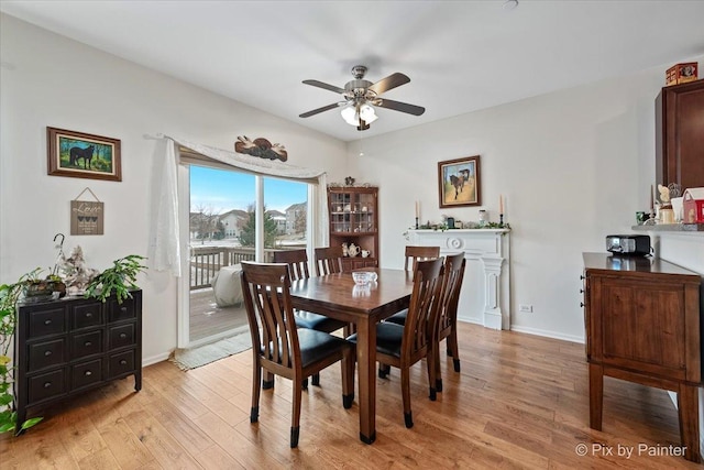 dining area with light hardwood / wood-style floors and ceiling fan