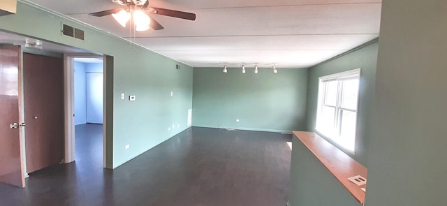 spare room featuring track lighting and ceiling fan