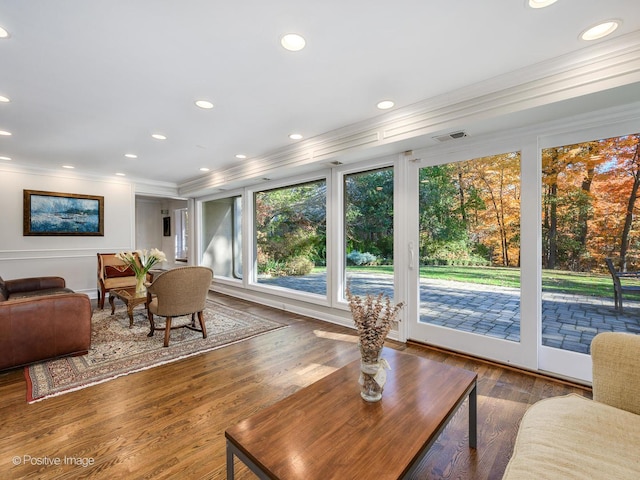 living room with ornamental molding and dark hardwood / wood-style flooring