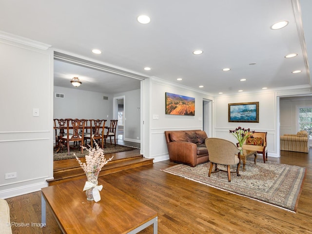 living room with ornamental molding and dark wood-type flooring