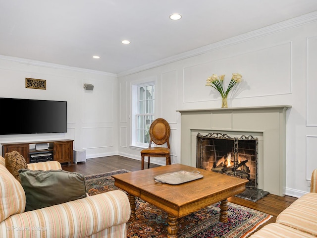 living room with dark hardwood / wood-style flooring and ornamental molding