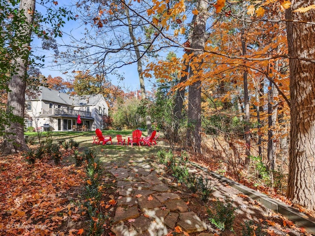 view of yard with a wooden deck and an outdoor fire pit