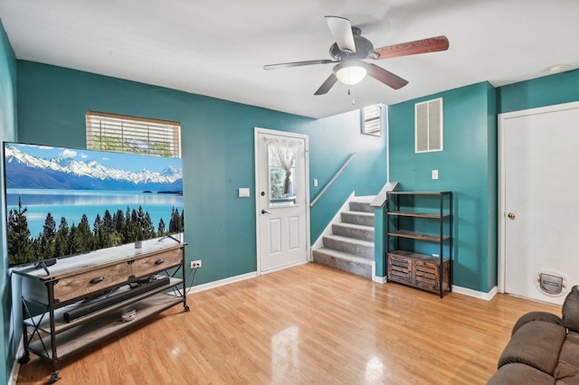 living room featuring ceiling fan and hardwood / wood-style flooring