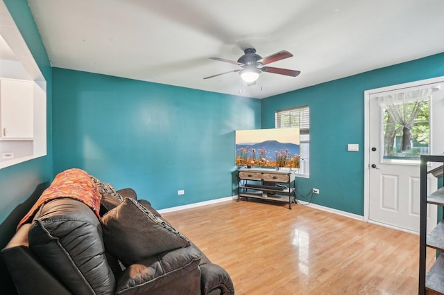 living room featuring ceiling fan and light hardwood / wood-style flooring