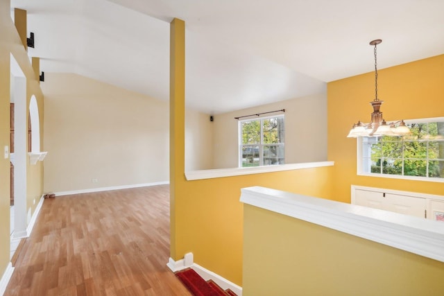 hall featuring a healthy amount of sunlight and hardwood / wood-style floors