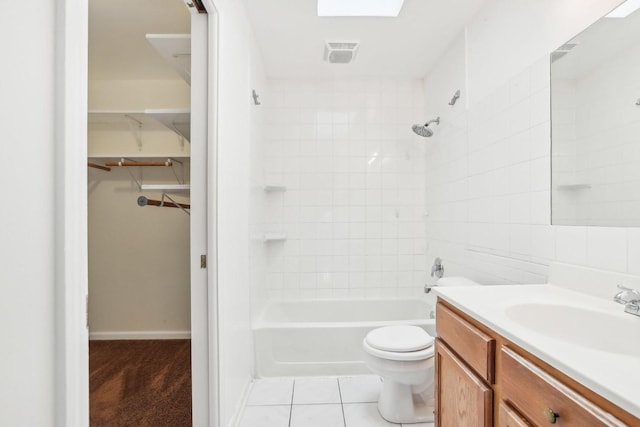 full bathroom featuring toilet, vanity, tile patterned floors, and tiled shower / bath combo