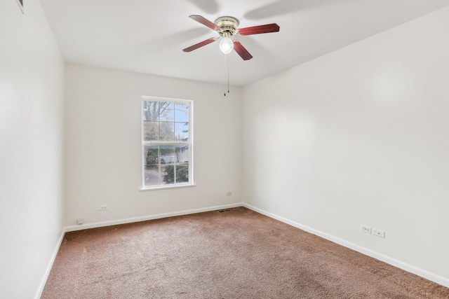 carpeted empty room featuring ceiling fan