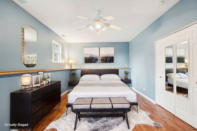 bedroom with ceiling fan, a closet, and hardwood / wood-style floors