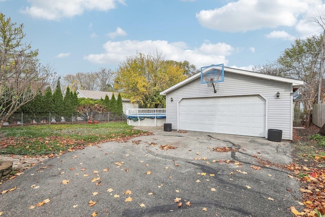 view of side of home with a garage and an outbuilding