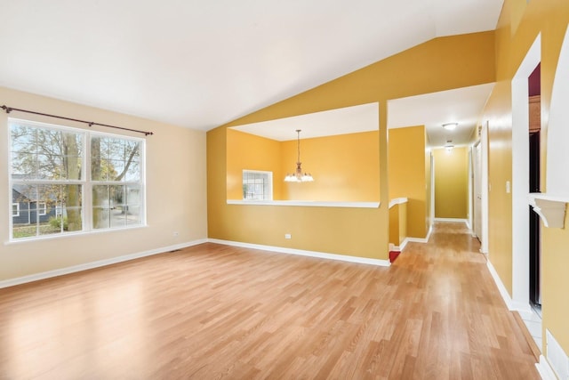 unfurnished living room featuring lofted ceiling, a chandelier, and wood-type flooring