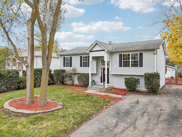 bi-level home with a front yard and a garage