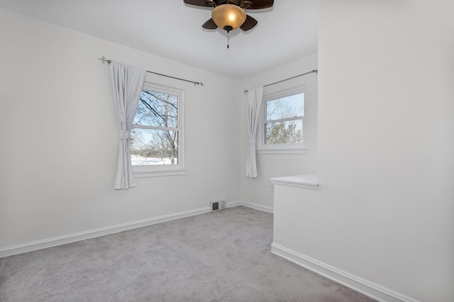 empty room with ceiling fan and light colored carpet