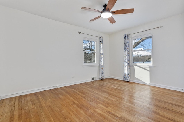 spare room featuring ceiling fan, plenty of natural light, and light hardwood / wood-style flooring