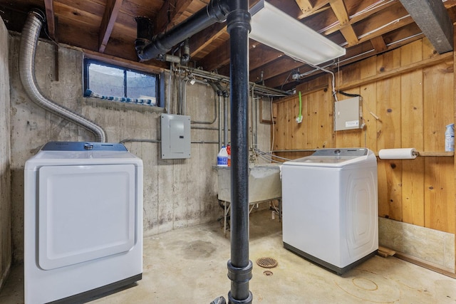 basement with washing machine and dryer, electric panel, and sink