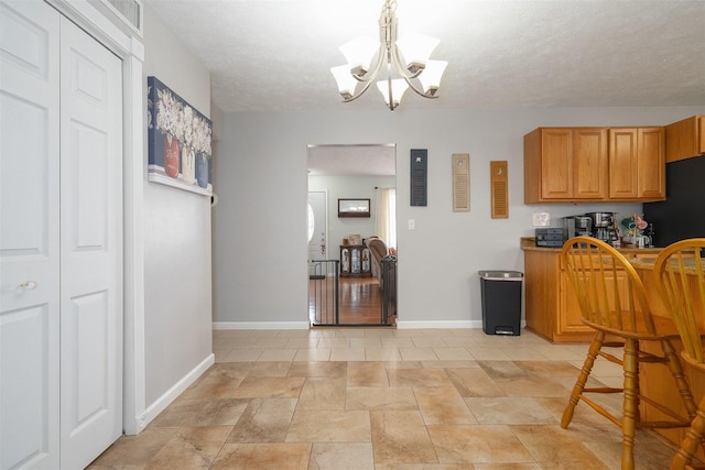 kitchen featuring a chandelier and a textured ceiling