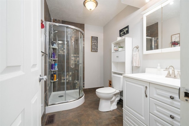 bathroom with a textured ceiling, toilet, an enclosed shower, and vanity