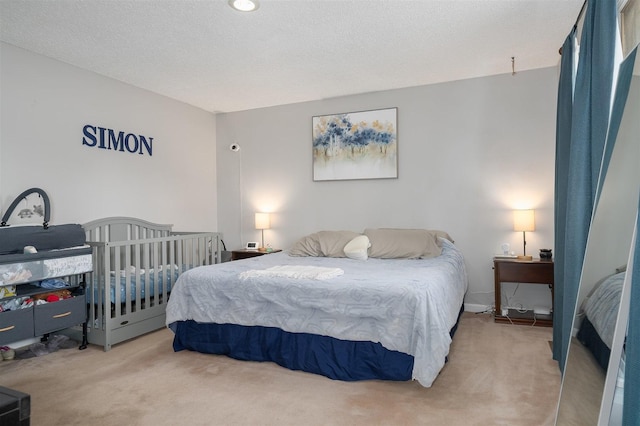 carpeted bedroom featuring a textured ceiling